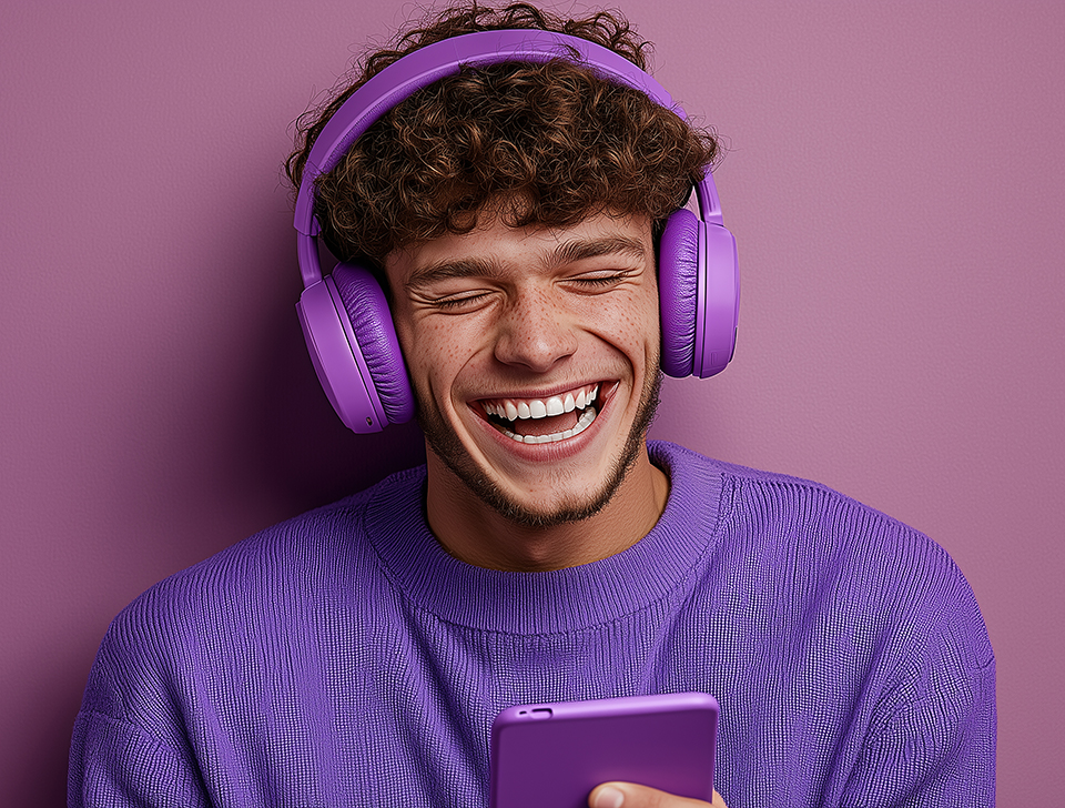 cheerful-young-man-listening-music-from-his-smartphone-with-headphones